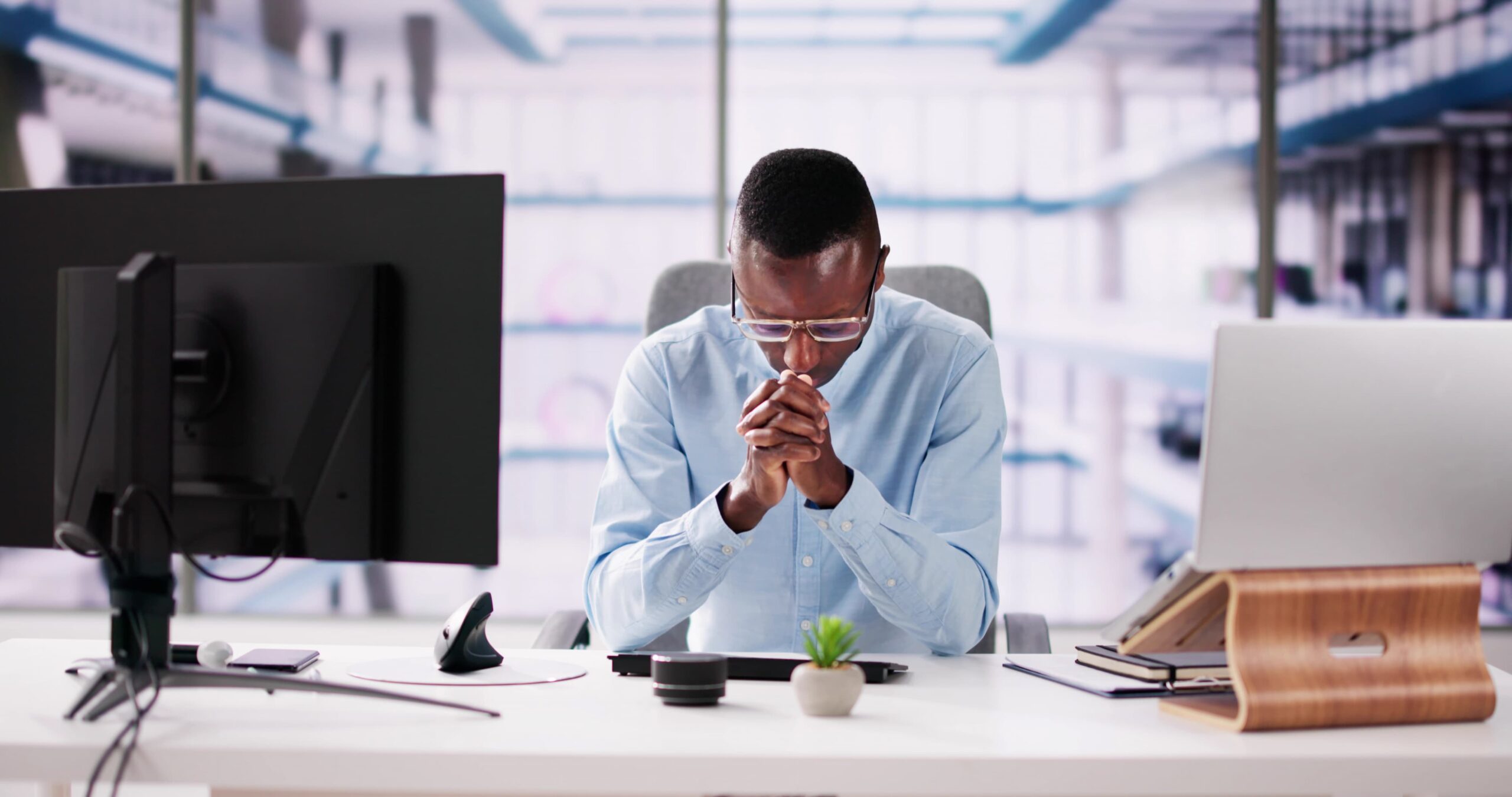 Man praying at his desk