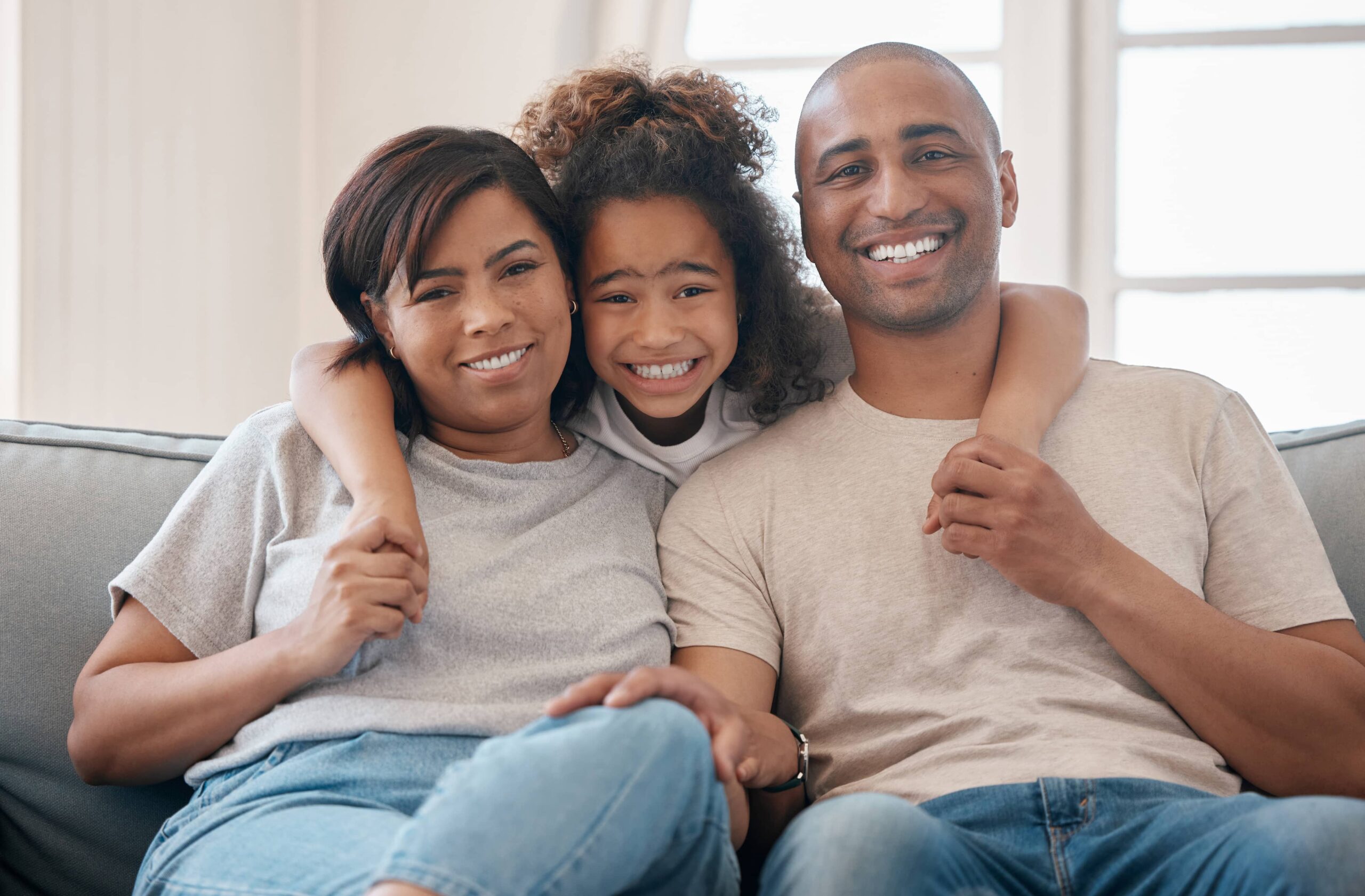 Family hugging, parents guiding their child